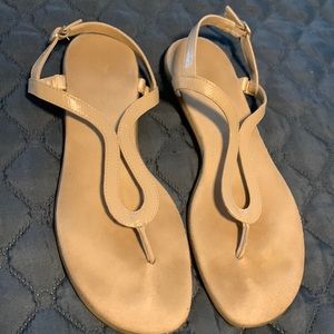 Nude color aerosol’s thong sandal.  .